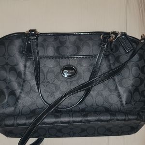 Black, leather Coach purse with handles/crossbody strap.